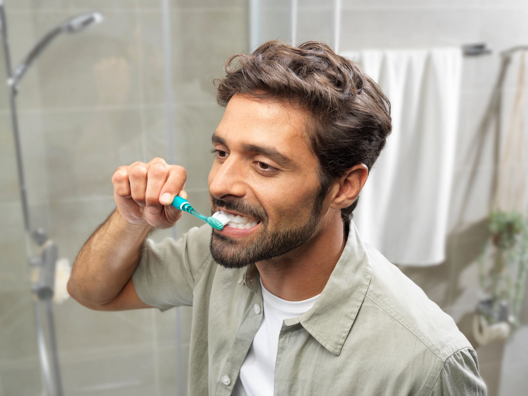 Man is brushing his teeth with GUM PRO Toothbrush