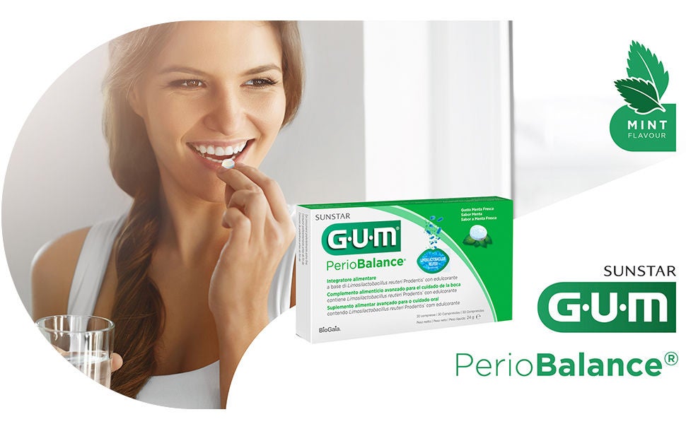 Smiling woman is putting the tablet GUM PerioBalance