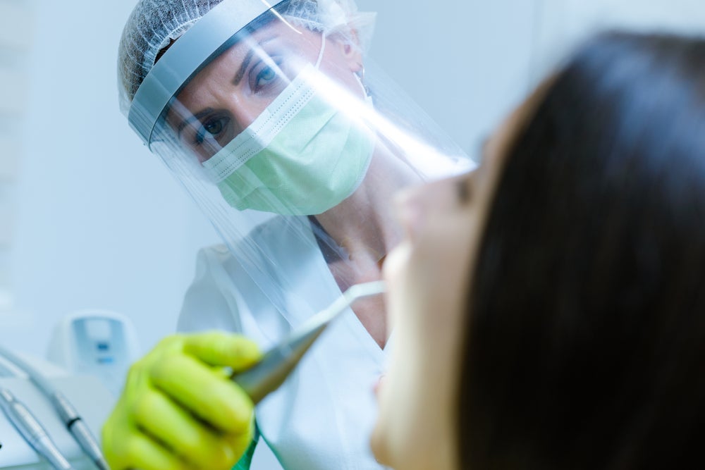 OCP-Dentist-woman-face-shield-green-gloves