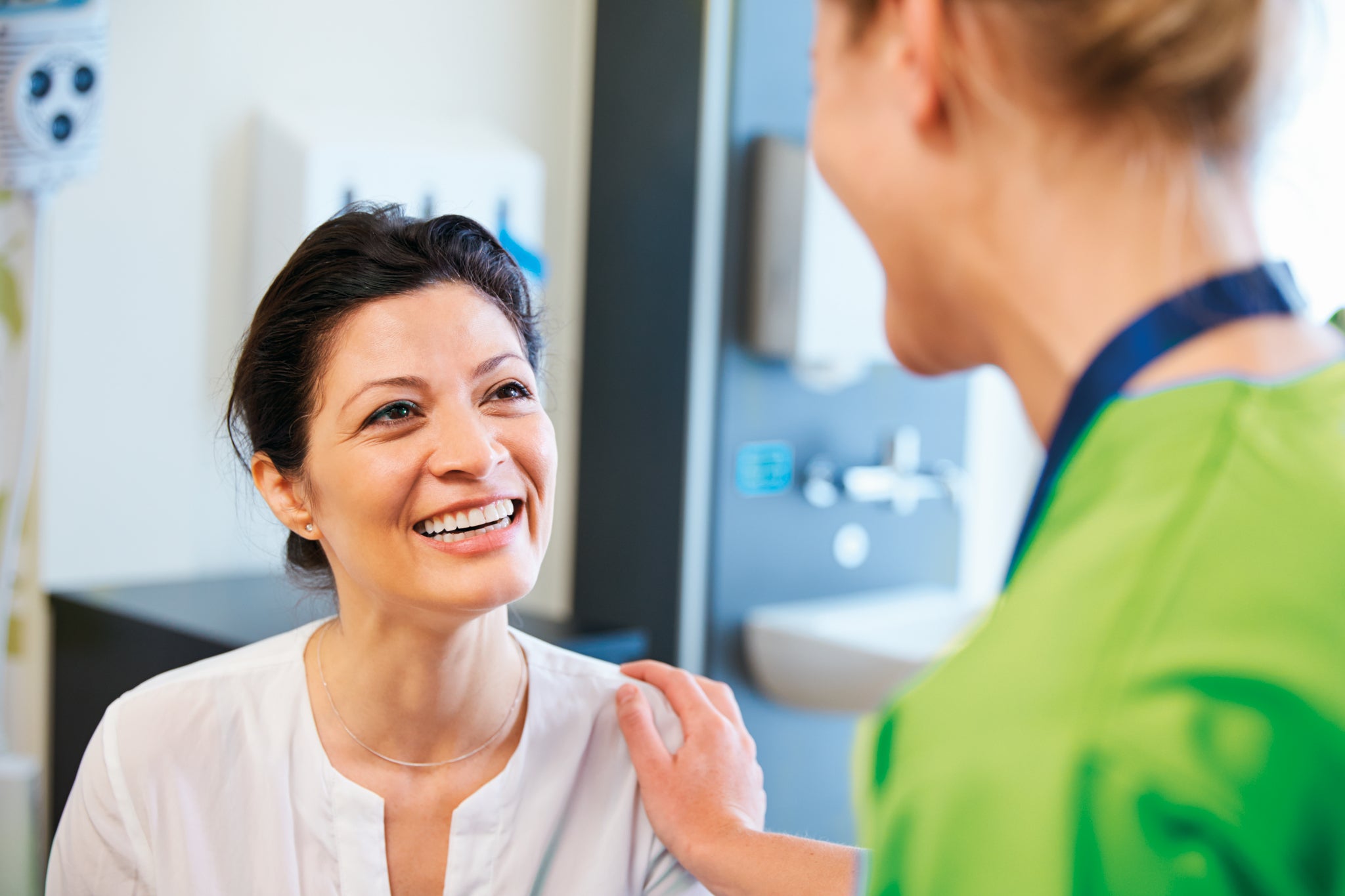 Smiling female patient at dentist office shutterstock_317573531