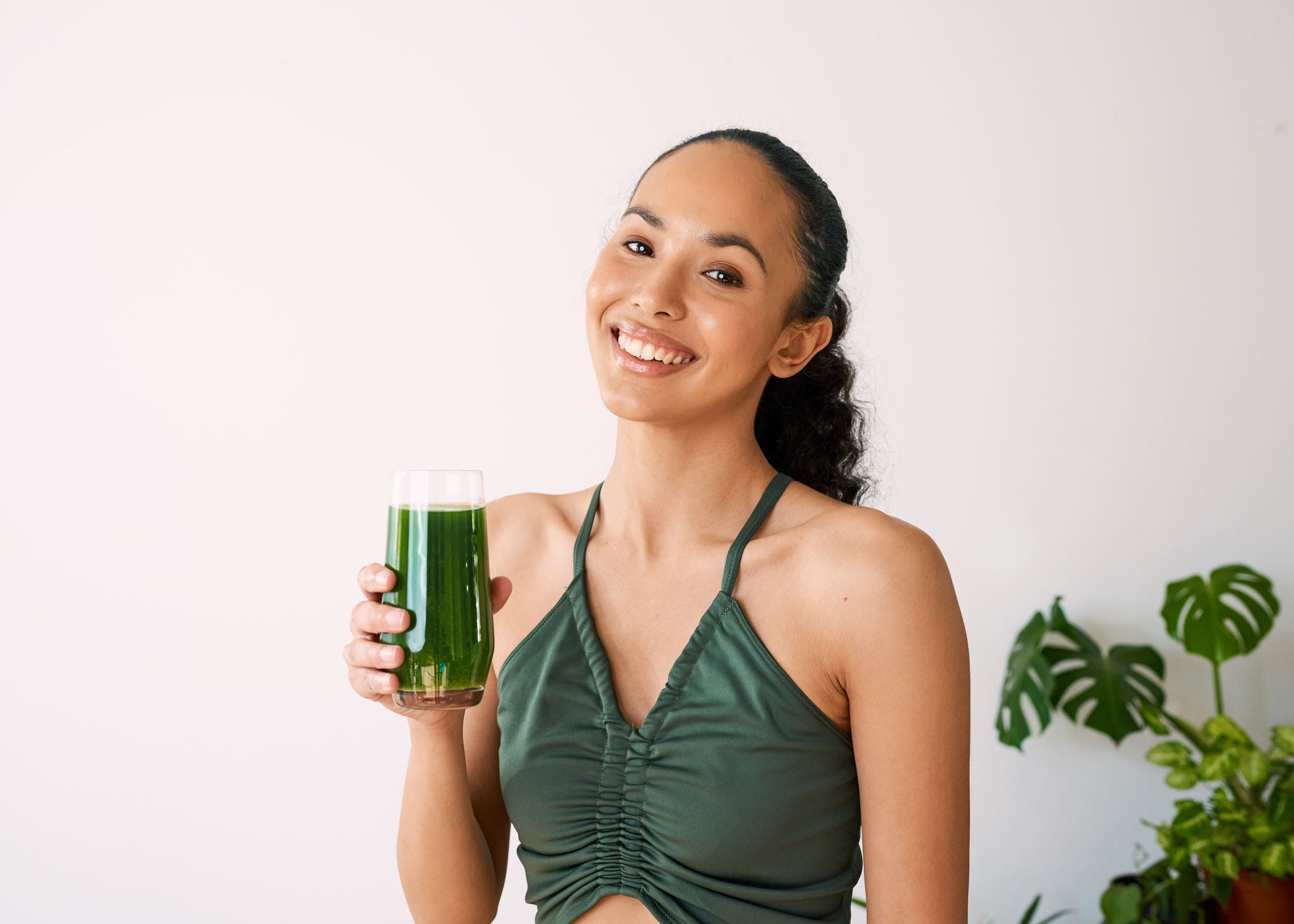 woman smiling and drinking juice